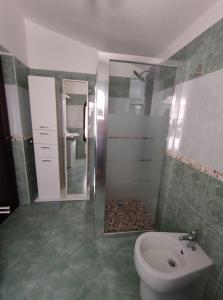 ein Badezimmer mit einem WC, einem Waschbecken und einem Spiegel in der Unterkunft Sagittario House in Torre delle Stelle