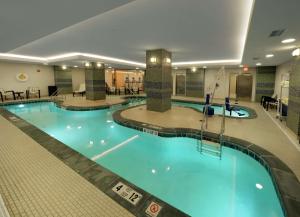 a large swimming pool in a hotel at The Hilton Garden Inn Buffalo-Downtown in Buffalo