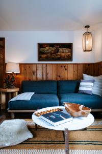 a living room with a blue couch and a coffee table at The Leeway in Mount Tremper