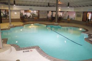a large swimming pool with blue water in a building at Embassy Suites Corpus Christi in Corpus Christi