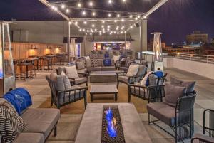 a patio with couches and chairs and a fire pit at Hilton Garden Inn Little Rock Downtown in Little Rock