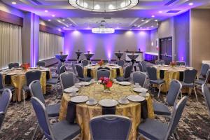 小石城Hilton Garden Inn Little Rock Downtown的配有桌椅和紫色灯光的宴会厅