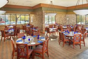 un comedor con mesas, sillas y ventanas en DoubleTree by Hilton Hotel Oak Ridge - Knoxville, en Oak Ridge