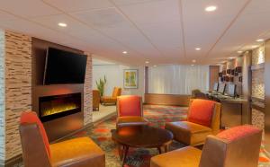 a lobby with a waiting room with a fireplace at Embassy Suites by Hilton Piscataway Somerset in Piscataway
