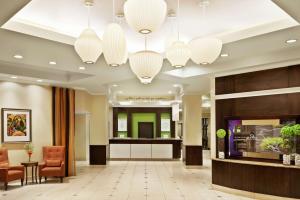 a lobby with a reception desk and chandeliers at Hilton Garden Inn Saskatoon Downtown in Saskatoon