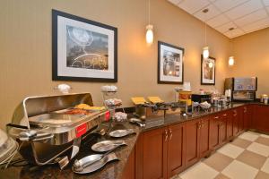 a restaurant with a counter with food on it at Hampton Inn Spokane Airport in Spokane