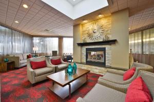 a lobby with couches chairs and a fireplace at Hampton Inn Spokane Airport in Spokane