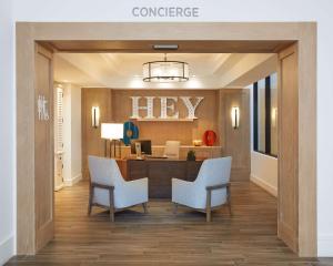 a lobby with a help desk and chairs in it at The Waterfront Beach Resort, A Hilton Hotel in Huntington Beach