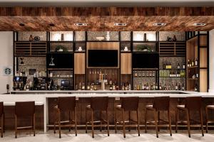 a bar in a restaurant with chairs around it at Hilton Garden Inn Mt. Juliet, TN in Mount Juliet