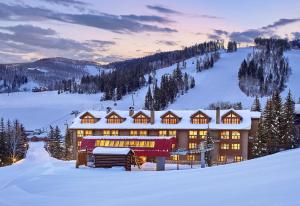 a large building in the snow with snow covered at The Osprey at Beaver Creek, a RockResort in Beaver Creek