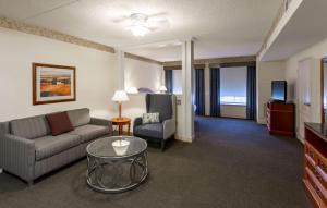 a living room with a couch and a table and a tv at Hilton Garden Inn Wooster in Wooster