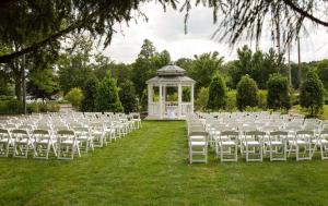 a row of white chairs in a field with a gazebo at Hilton Chicago/Northbrook in Northbrook