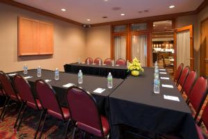 a conference room with a long table with chairs and water bottles at Homewood Suites Dayton-Fairborn in Fairborn
