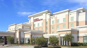 una representación de la parte delantera de un edificio hospitalario en Hilton Garden Inn Houston Cypress Station en Westfield