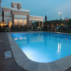 a large swimming pool in front of a building at Hilton Garden Inn Houston Cypress Station in Westfield