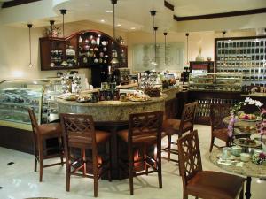 a restaurant with a bar with chairs and a counter at DoubleTree by Hilton Torrance - South Bay in Torrance