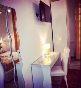 a room with a desk with a lamp and a bed at B&B Crystal in Messina +25 photos