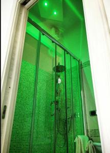 a bathroom with a shower with green lights at B&B Crystal in Messina