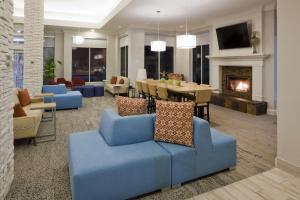 a living room with a blue couch and a fireplace at Hilton Garden Inn Minneapolis Eagan in Eagan