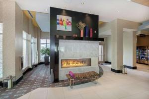 a lobby with a fireplace in a building at Hilton Garden Inn Raleigh/Crabtree Valley in Raleigh