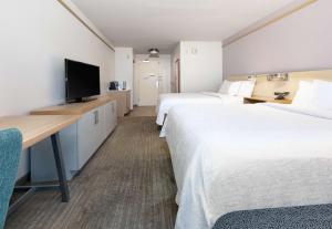 a hotel room with two beds and a television at Hilton Garden Inn Irvine East/Lake Forest in Foothill Ranch +31 photos