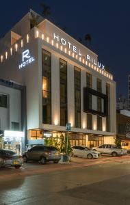 un edificio di un hotel con auto parcheggiate di fronte di HOTEL RILUX CARTAGENA a Cartagena de Indias