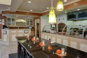 a large kitchen with a large island in the middle at Hilton Garden Inn Tulsa Airport in Tulsa