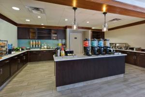 a large kitchen with a counter with drinks on it at Homewood Suites by Hilton Chesapeake - Greenbrier in Chesapeake
