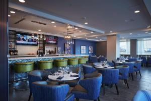 a restaurant with tables and chairs and a bar at Hilton Garden Inn St. John's Newfoundland, Canada in St. John's