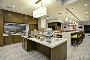 a large kitchen with wooden cabinets and a large island at Hilton Garden Inn By Hilton Phoenix/Tempe Asu Area, Az in Tempe