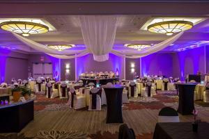 a banquet hall with white tables and purple at DoubleTree by Hilton Pittsburgh-Green Tree in Pittsburgh +20 photos