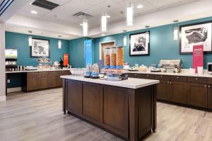 a store with blue walls and a counter with food at Hampton Inn Acworth in Acworth