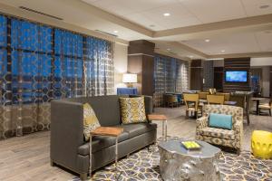 a lobby with a couch and chairs and a table at Hampton Inn & Suites Grand Rapids Downtown in Grand Rapids