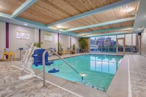 a swimming pool in a hotel room with a gym at Home 2 Suites By Hilton Indianapolis Northwest in Indianapolis