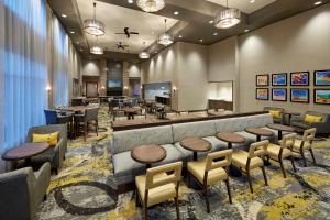 a restaurant with a bar with tables and chairs at Homewood Suites By Hilton Los Angeles Redondo Beach in Redondo Beach