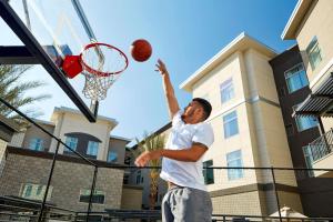 a man throwing a basketball into the hoop at Homewood Suites By Hilton Los Angeles Redondo Beach in Redondo Beach