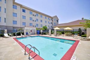 a swimming pool in front of a building at Homewood Suites by Hilton Tulsa-South in Broken Arrow