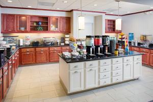 a large kitchen with wooden cabinets and a counter top at Homewood Suites Lancaster in Lancaster