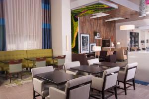 a restaurant with tables and chairs in a room at Hampton Inn & Suites by Hilton Augusta-Washington Rd in Augusta