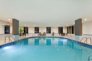 a large pool in a hotel with blue water at Hampton Inn Norcross in Norcross