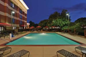 a large swimming pool with chairs and a hotel at Hampton Inn Atlanta-Stone Mountain in Stone Mountain