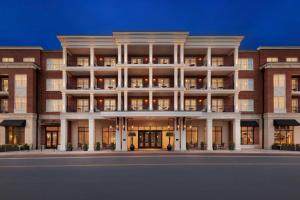 a large brick building with a lit up facade at The Harpeth Downtown Franklin, Curio Collection by Hilton in Franklin
