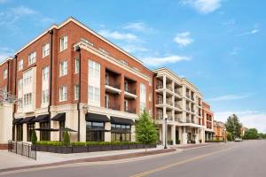 a rendering of a brick building on a street at The Harpeth Downtown Franklin, Curio Collection by Hilton in Franklin