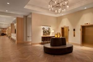 a lobby with a circular chair and a chandelier at The Harpeth Downtown Franklin, Curio Collection by Hilton in Franklin