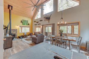 a living room with a table and a dining room at Soldotna Home with 2 Living Areas and Spacious Porch in Soldotna