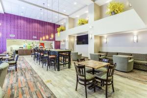 a restaurant with tables and chairs and a bar at Hampton Inn & Suites Chicago - Libertyville in Libertyville