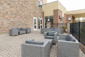 a patio with couches and chairs in front of a building at Hilton Garden Inn West Des Moines in West Des Moines