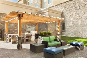 a pergola on a patio with a table and chairs at Homewood Suites by Hilton Frederick in Frederick