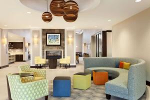 a living room with a couch and chairs at Homewood Suites by Hilton Frederick in Frederick