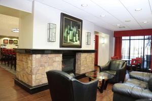 a lobby with a fireplace and chairs and a table at Hampton Inn & Suites Temecula in Temecula